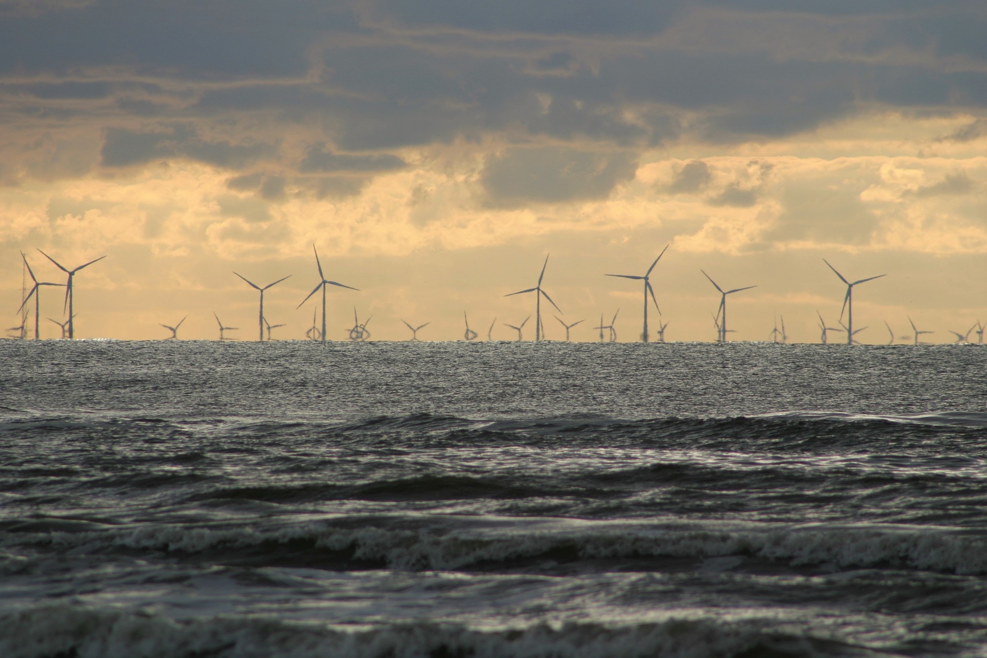 Offshore windmills (Photo: David Will via Pixabay) Windmills and stormy ocean