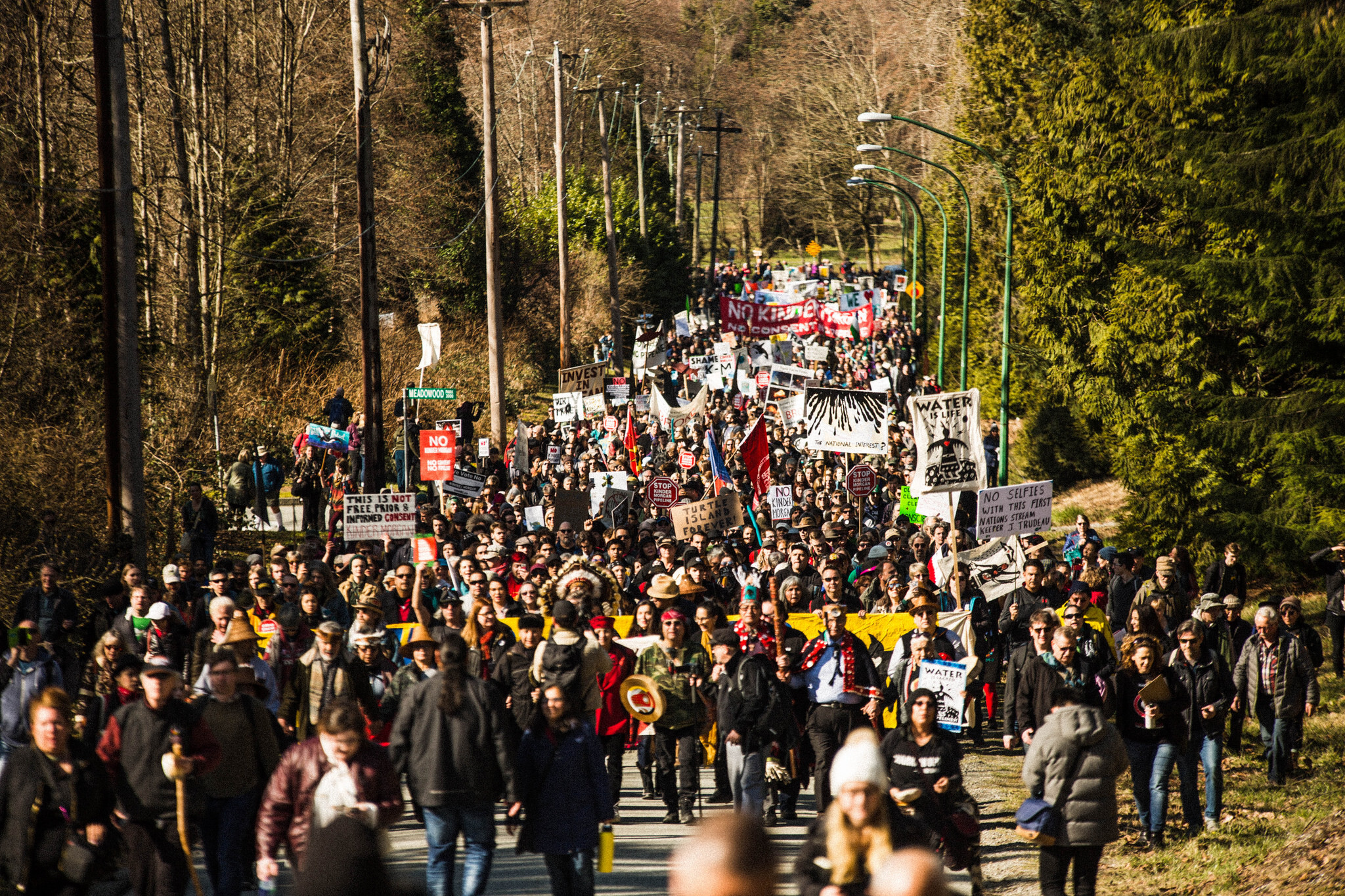 Crowds marching in opposition to Trans Mountain in Burnaby, BC, 2018. Photo: Ian MacKenzie Large crowd marching with signs and banners opposing Trans Mountain