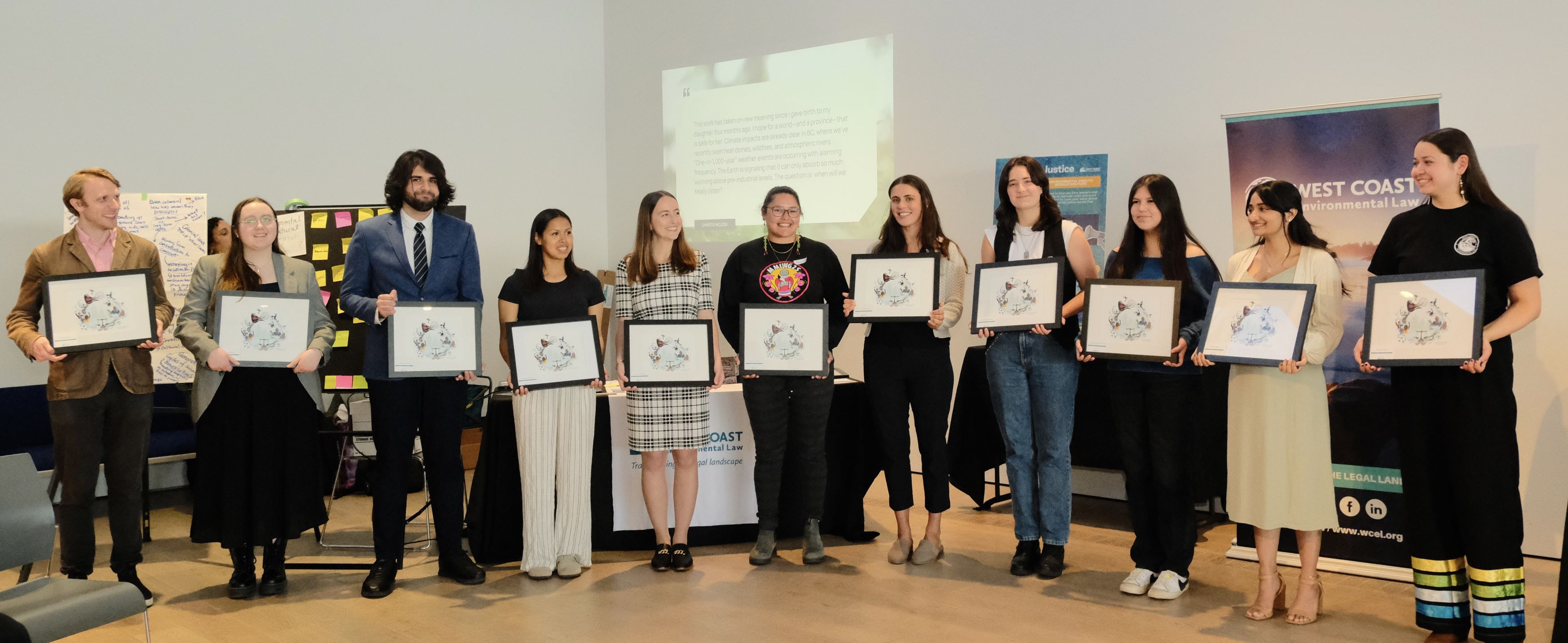 11 youth posing with framed artwork awards