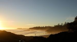 Wide shot of a person standing on the beach (Tofino, BC)