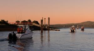 Sport fishing boats heading out on the water next to docks at sunrise