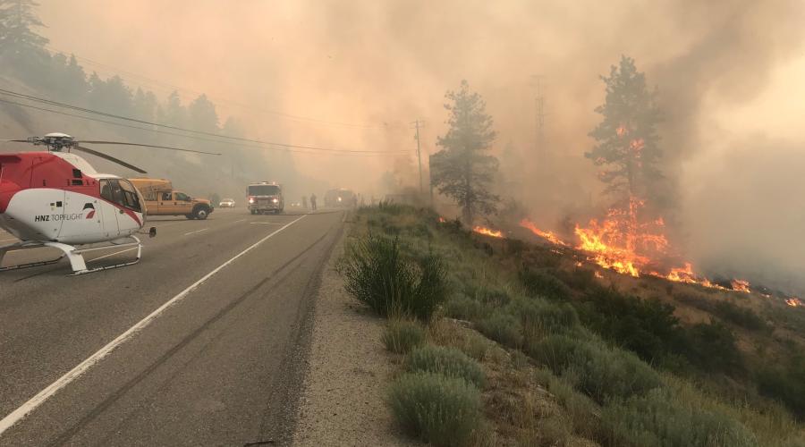 Helicopter at a roadside fire near Peachland, BC (Photo: BC Ministry of Transportation / Flickr)